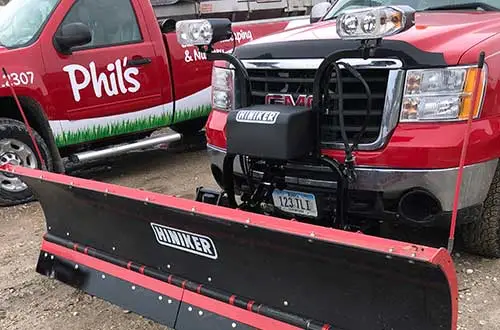 Phil's Lawn & Landscaping company truck equipped with snow plow in Denison, IA.